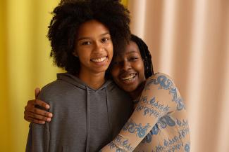 young women hug african american