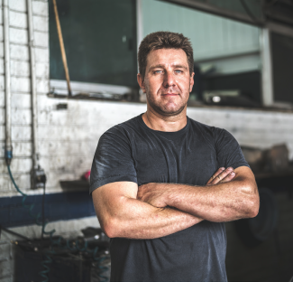 Construction worker posing with arms crossed