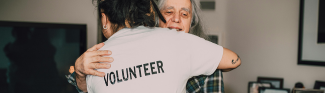 Volunteer giving a hug