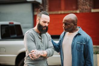 One man conversing with another man in distress.